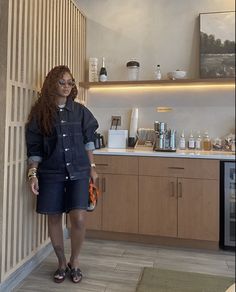 a woman standing next to a kitchen counter