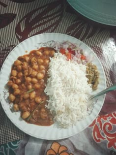 a white plate topped with rice and beans