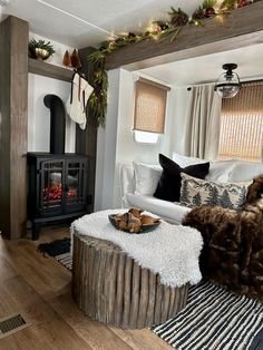 a living room filled with furniture and a fire place next to a wooden burning stove