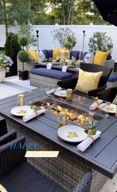 an outdoor table with yellow and blue pillows