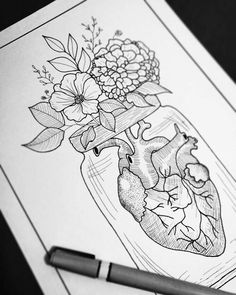 a drawing of a heart in a jar with flowers on it next to a pen