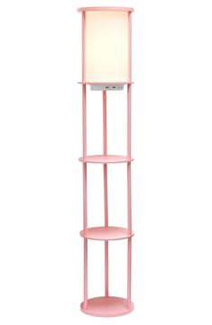 a pink shelf with a lamp on top and a white light in the corner next to it