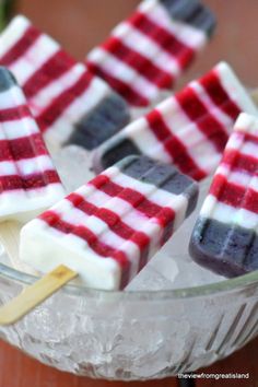 red, white and blue popsicles in a glass bowl