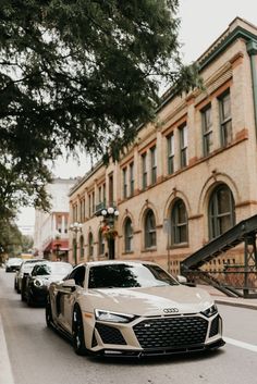 several cars parked on the street in front of an old building