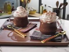 two glasses of hot chocolate on a tray