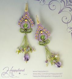 two purple and green beaded earrings on top of a white surface with an ornate design