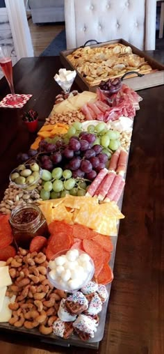 a long table filled with lots of different types of food and snacks on it's sides