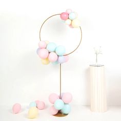 there is a vase with balloons on it next to a stand that has balls in it