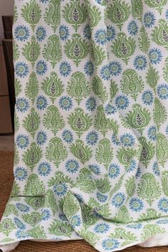 a green and blue blanket sitting on top of a chair