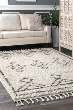 a living room with a white couch and rug