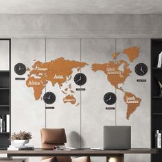 a desk with a laptop on it in front of a wall with clocks and world map