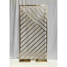 a gold and white metal frame with lines on the sides, against a white background