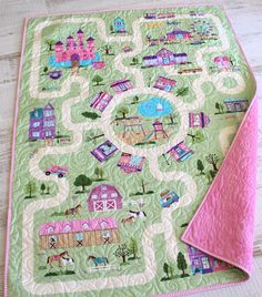 a quilted table runner with a pink napkin on top of it and a green background