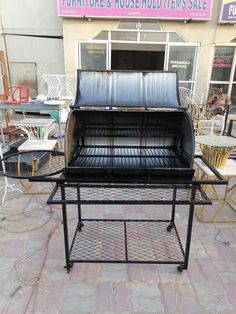 an outdoor bbq grill sitting in front of a building