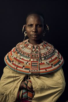 an african woman in traditional clothing poses for the camera with her hands on her hips