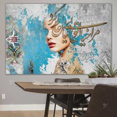 a painting on the wall above a dining room table with chairs and a potted plant