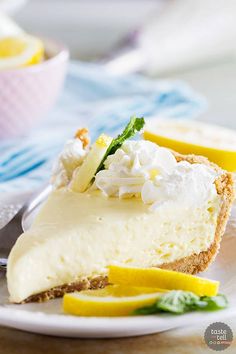 a slice of cheesecake with lemons and whipped cream