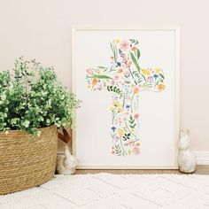 a cross made out of flowers is next to a basket with some plants in it