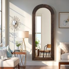 a living room filled with furniture and a large mirror on the wall next to a window