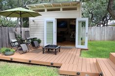 a small backyard with decking and patio furniture