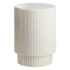 a white vase sitting on top of a table