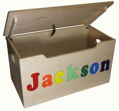 a wooden toy box with the word jackson painted on it's lid and handles