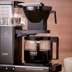 a black coffee maker sitting on top of a counter