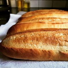 three loaves of bread sitting on top of a white towel