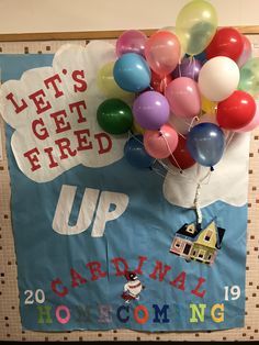 there is a sign with balloons attached to it that says let's get fired up