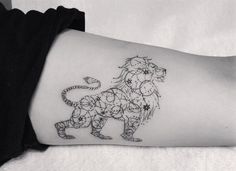 a black and white photo of a lion tattoo on the left side of the arm