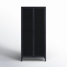 a tall black cabinet sitting on top of a white floor