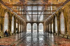 the inside of an old building with people sitting on benches