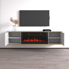 an entertainment center with a fire place and television on it's stand, in front of a white wall