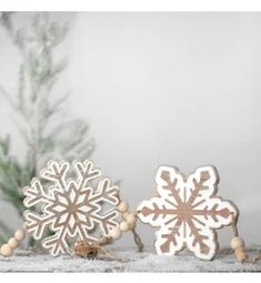 three wooden snowflakes sitting on top of a table