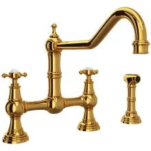 a golden faucet with two handles and three sprayers on the side, in front of a white background