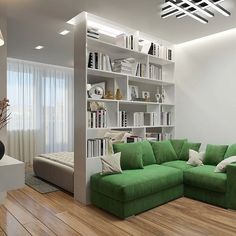 a green couch sitting in front of a book shelf