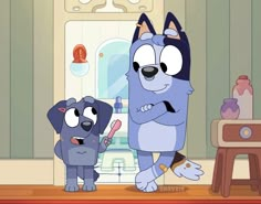 two cartoon dogs standing next to each other in front of a table with an object on it