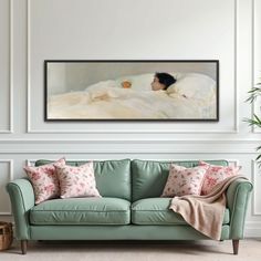 a painting on the wall above a green couch