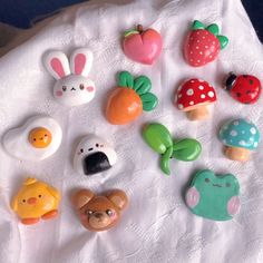 there are many different types of buttons on the table cloth, including an egg, mushroom, and other items