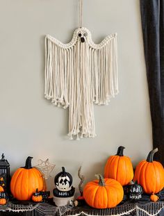 some pumpkins and other decorations on a mantle