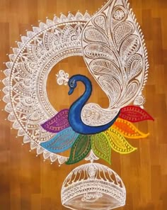 a peacock painted on top of a wooden floor