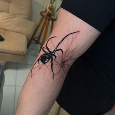 a person with a spider tattoo on their arm