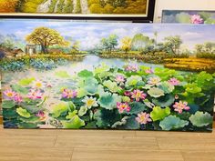 three paintings are on the floor next to each other and one has water lillies in it