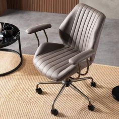 an office chair sitting on top of a rug in front of a table with a coffee cup