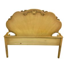 an antique gold shell shaped bed frame