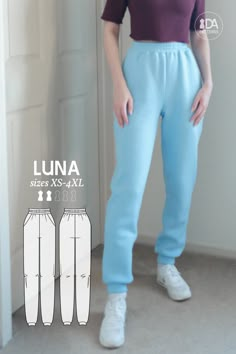 a woman standing in front of a door wearing blue pants and a purple shirt with the words luna sizes x - xxl on it