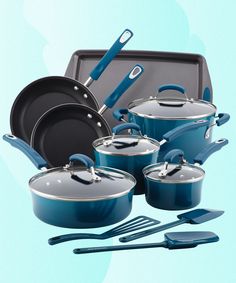 an assortment of pots and pans on a blue background with utensils in the foreground