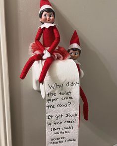 an elf is sitting on top of a toilet paper roll