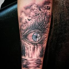 an all seeing eye tattoo on the arm