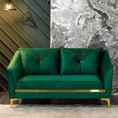 a green couch sitting in front of a wall